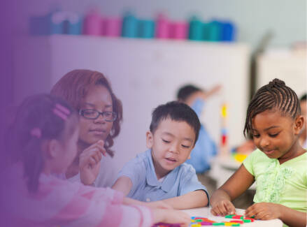 Teacher and three early childhood students working at a table